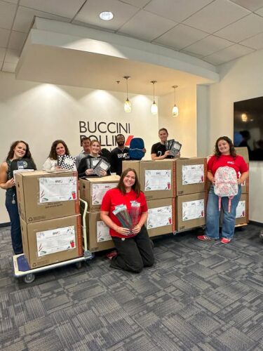 BPG associates standing with donated school supplies and hygiene essentials for Wilmington students as part of the 2026 BPG Cares drive.